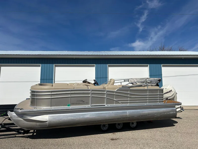 Slide: The Image of 2012 Bennington 2250RCL pontoon boat parked outside blue garage. - 34
