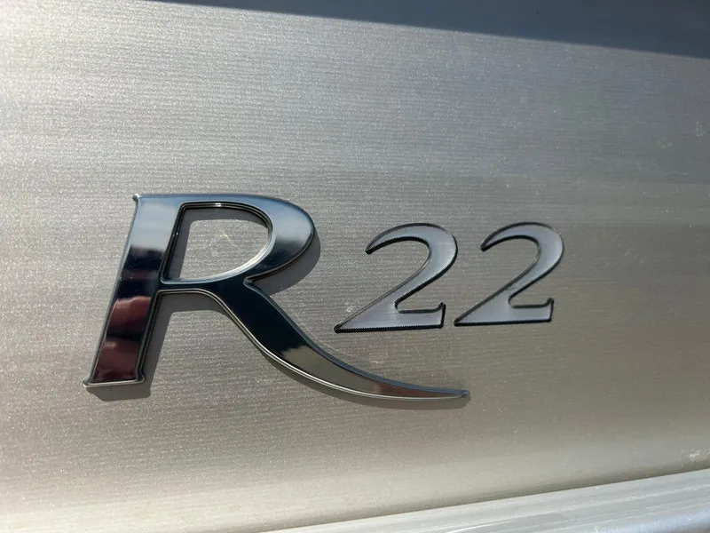 Slide: The Image of Chrome "R22" emblem on a 2012 Bennington 2250RCL boat. - 36