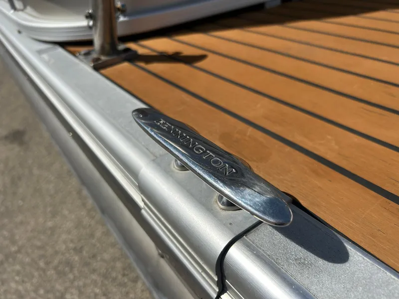 Slide: The Image of Bennington 2250RCL 2012 boat cleat on wooden deck, close-up view. - 41