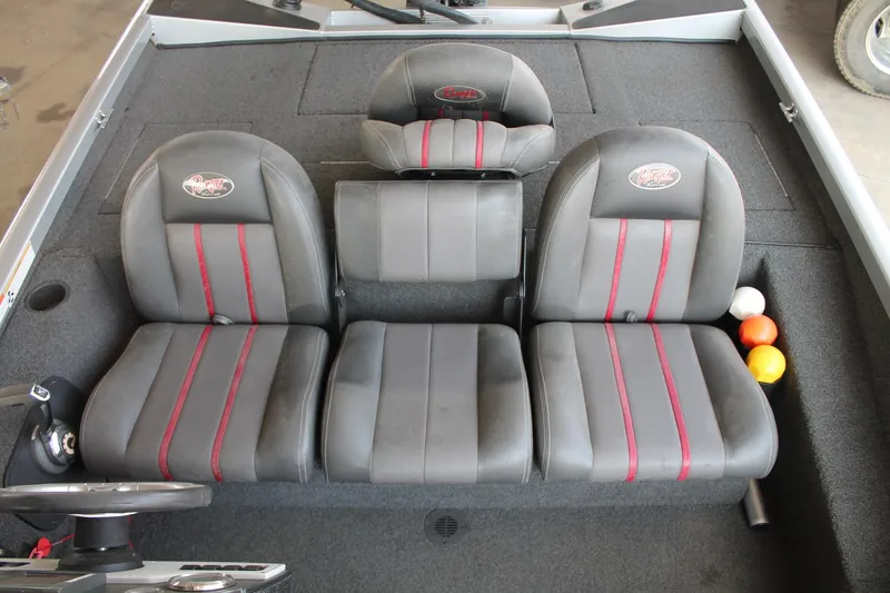 Slide: The Image of 2013 Ranger RT188 boat interior with gray and red seats, steering wheel, and storage area. - 13