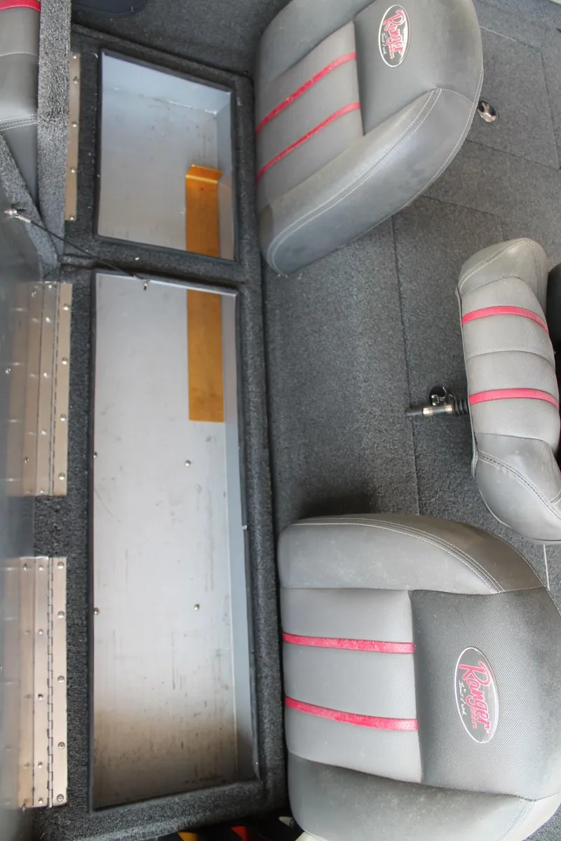 Slide: The Image of Interior of a 2013 Ranger RT188 boat with gray and red seats. - 14