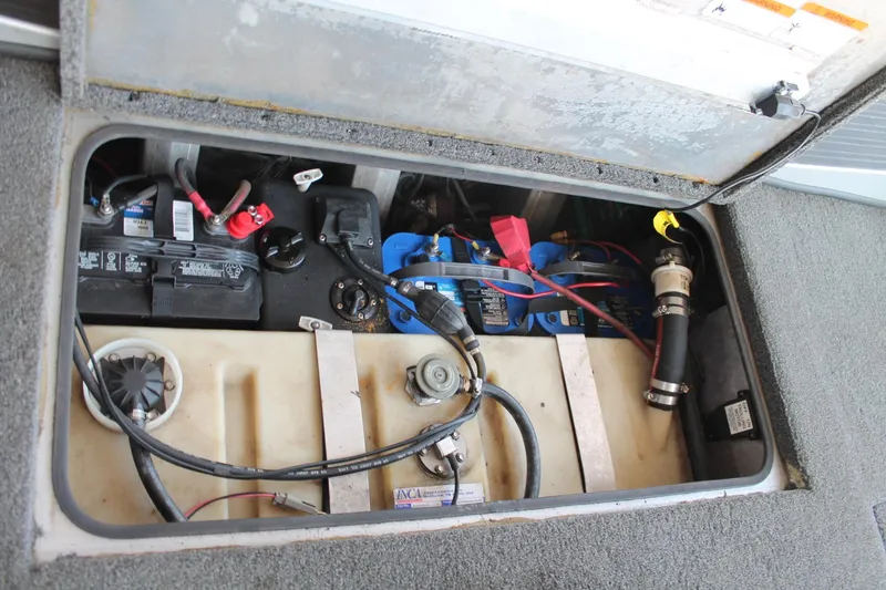 Slide: The Image of 2013 Ranger RT188 boat battery compartment with wiring and components. - 18