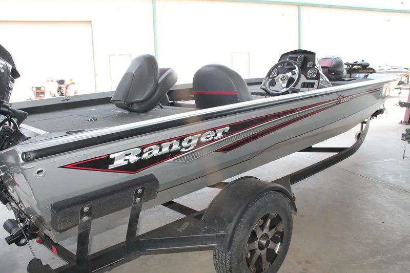 Slide: The Image of 2013 Ranger RT188 fishing boat on trailer, side view in a garage setting. - 4