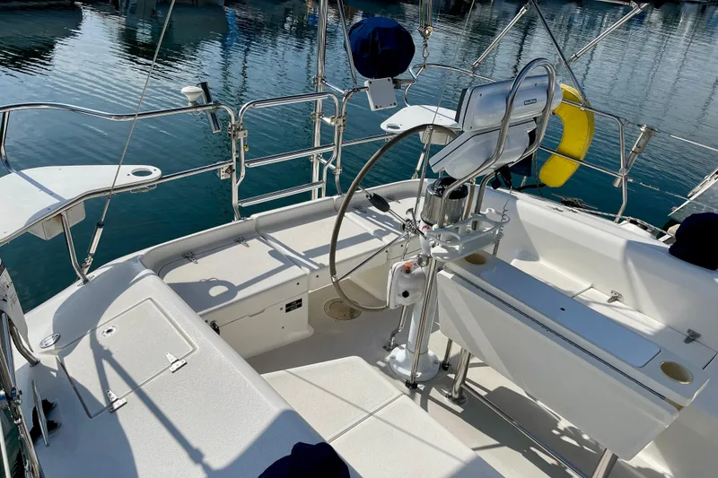 Slide: The Image of Cockpit of a 2001 Catalina 380 sailboat with steering wheel and seating. - 14