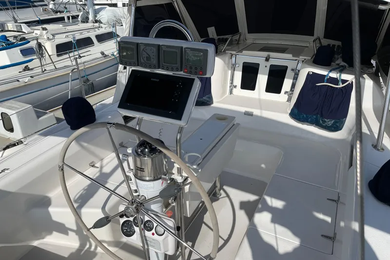 Slide: The Image of Cockpit of a 2001 Catalina 380 sailboat with navigation instruments and steering wheel. - 15