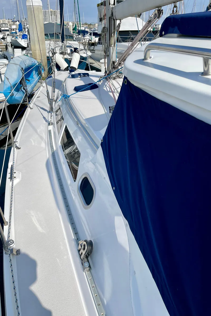 Slide: The Image of Catalina 380 sailboat, 2001 model, docked in marina with blue canvas cover. - 18