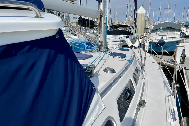 Slide: The Image of Catalina 380 sailboat, 2001 model, docked in marina with blue canvas cover. - 19