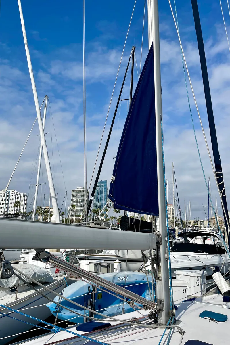 Slide: The Image of Catalina 380 sailboat from 2001 docked in a marina with city skyline background. - 21
