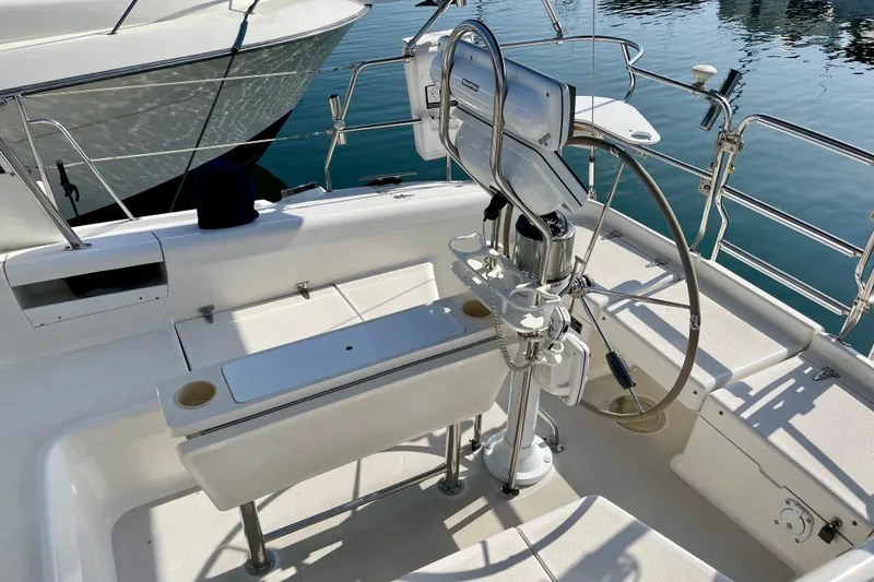 Slide: The Image of Cockpit of a 2001 Catalina 380 sailboat with steering wheel and seating. - 23