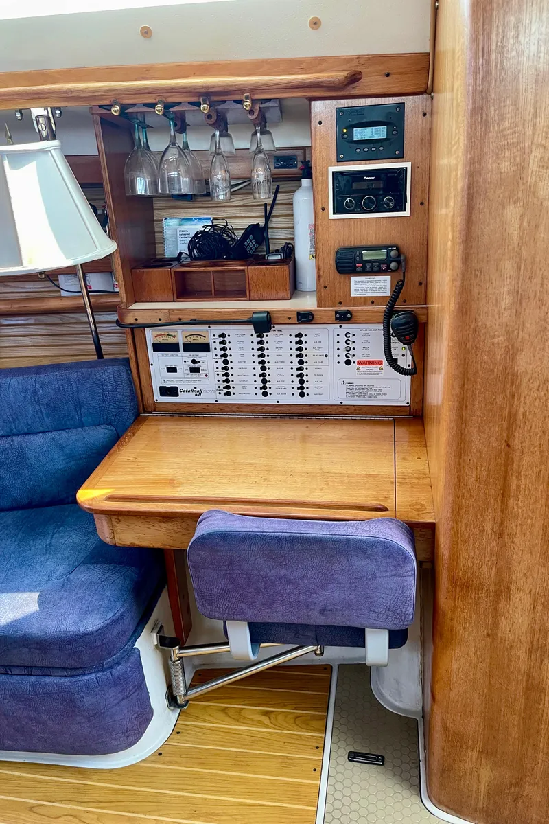 Slide: The Image of Interior of a 2001 Catalina 380 sailboat with navigation station and seating area. - 35