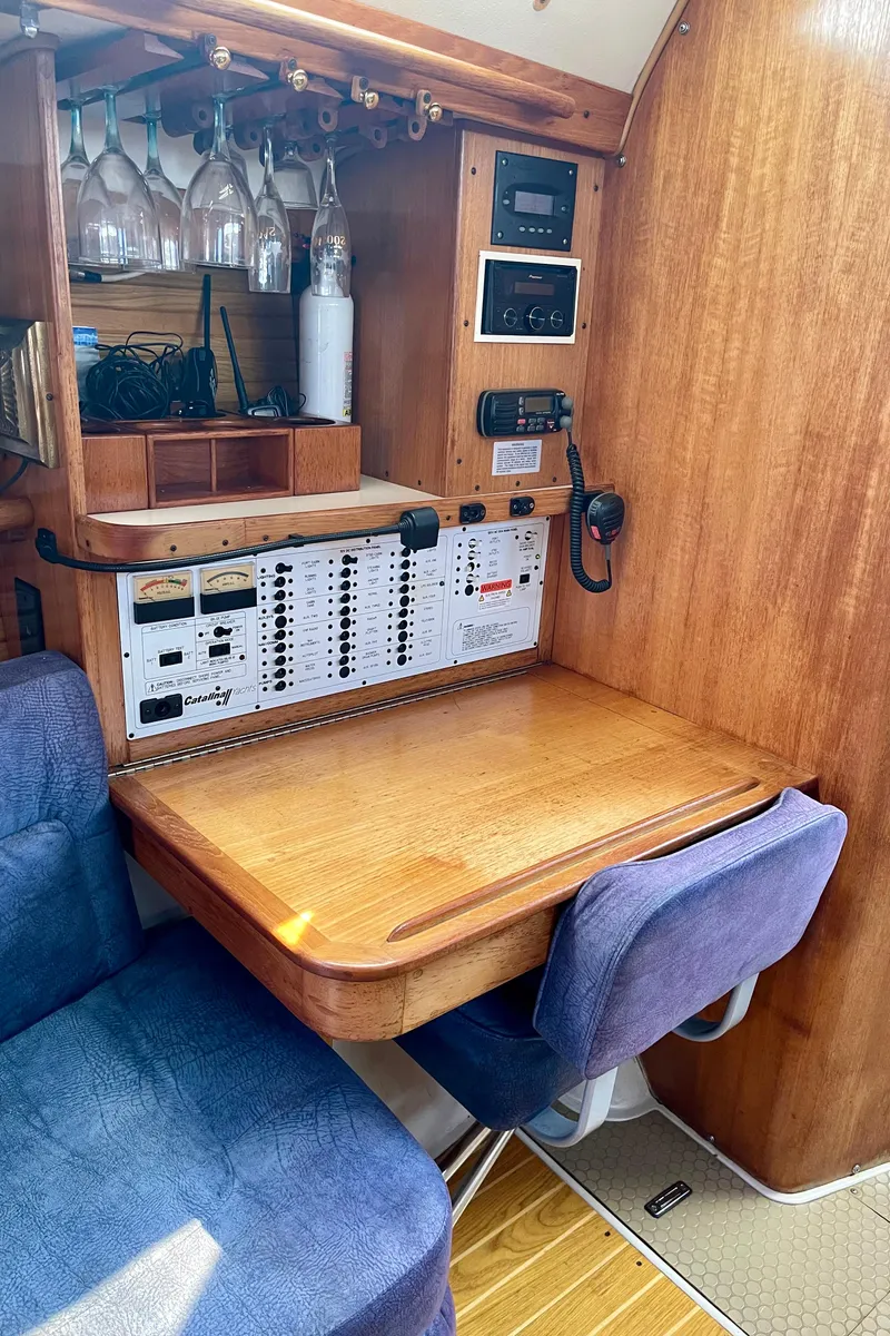 Slide: The Image of 2001 Catalina 380 yacht interior with navigation station and seating area. - 39