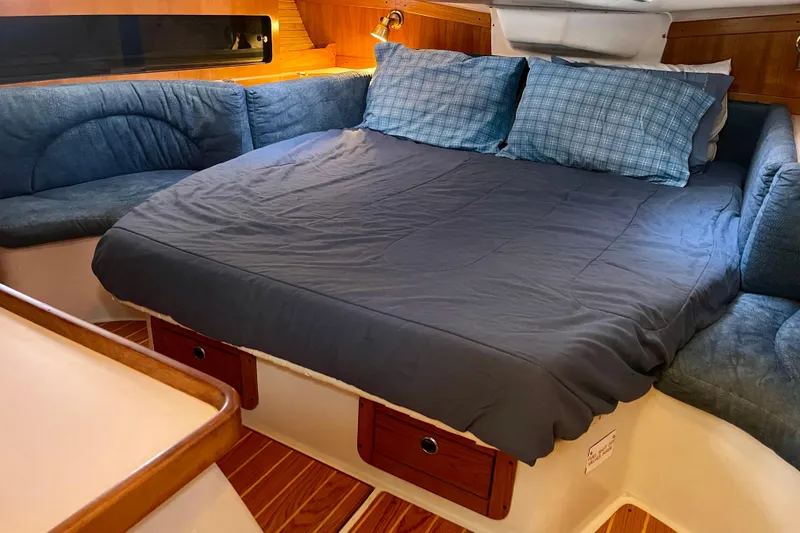 Slide: The Image of Cozy cabin interior of 2001 Catalina 380 sailboat with comfortable bedding and seating. - 45