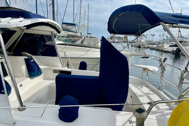 Slide: The Image of 2001 Catalina 380 sailboat with blue covers docked in a marina. - 5