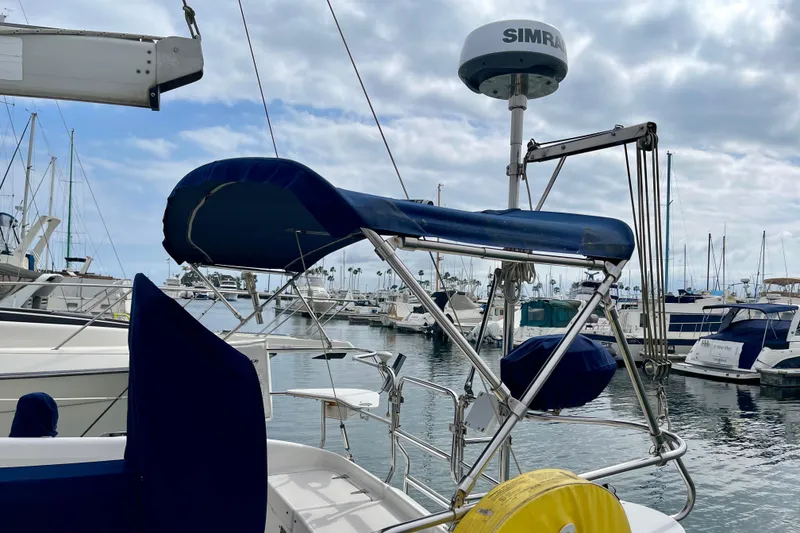 Slide: The Image of Catalina 380 sailboat, 2001 model, docked at marina with blue canopy and radar equipment. - 7