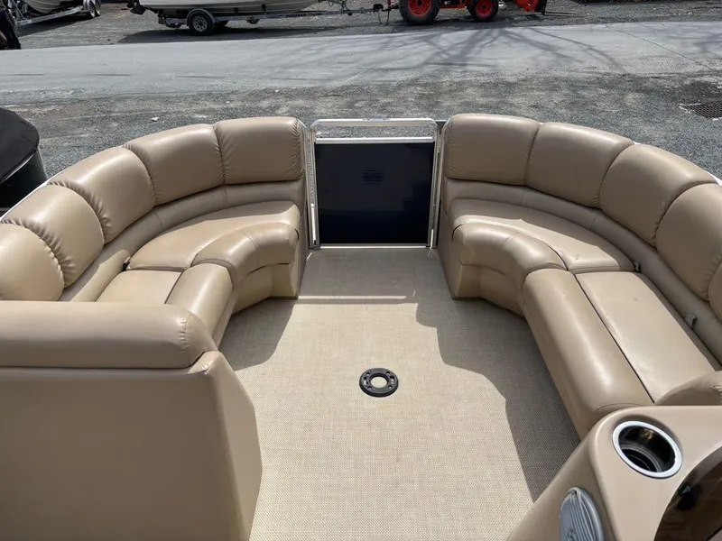 Slide: The Image of 2014 Harris Cruiser 220 pontoon boat with beige seating and spacious interior. - 10