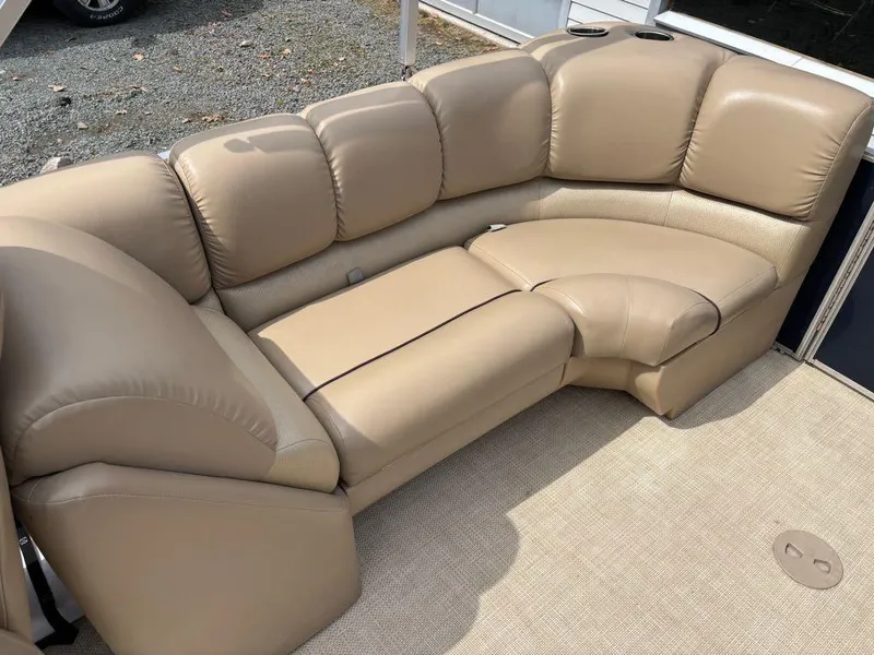 Slide: The Image of 2014 Harris Cruiser 220 boat with beige leather seating and cup holders. - 11