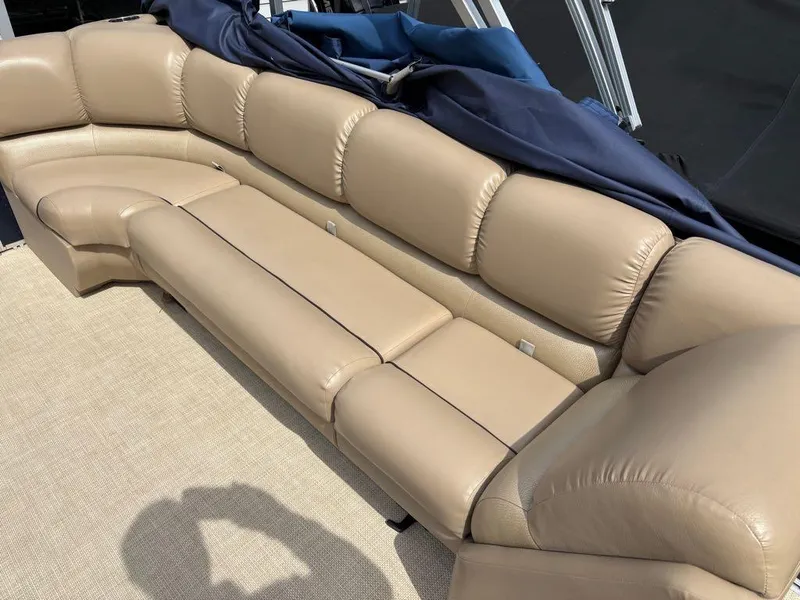 Slide: The Image of 2014 Harris Cruiser 220 boat with beige leather seating and blue cover. - 13