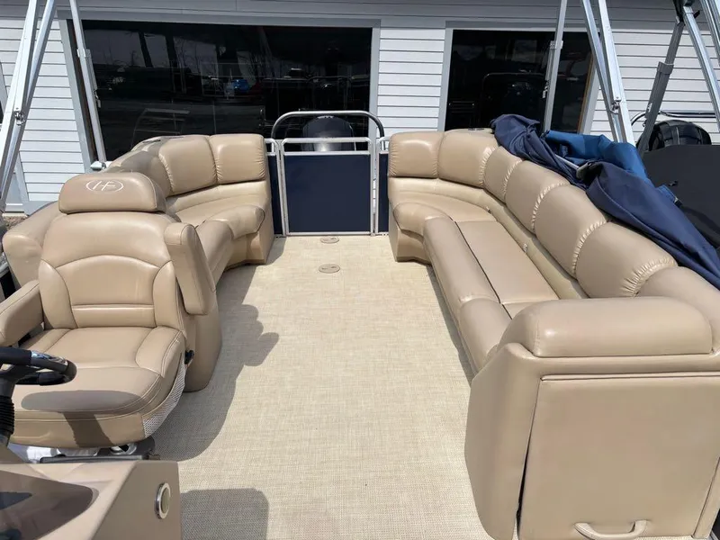 Slide: The Image of 2014 Harris Cruiser 220 pontoon boat with beige seating and spacious deck. - 19