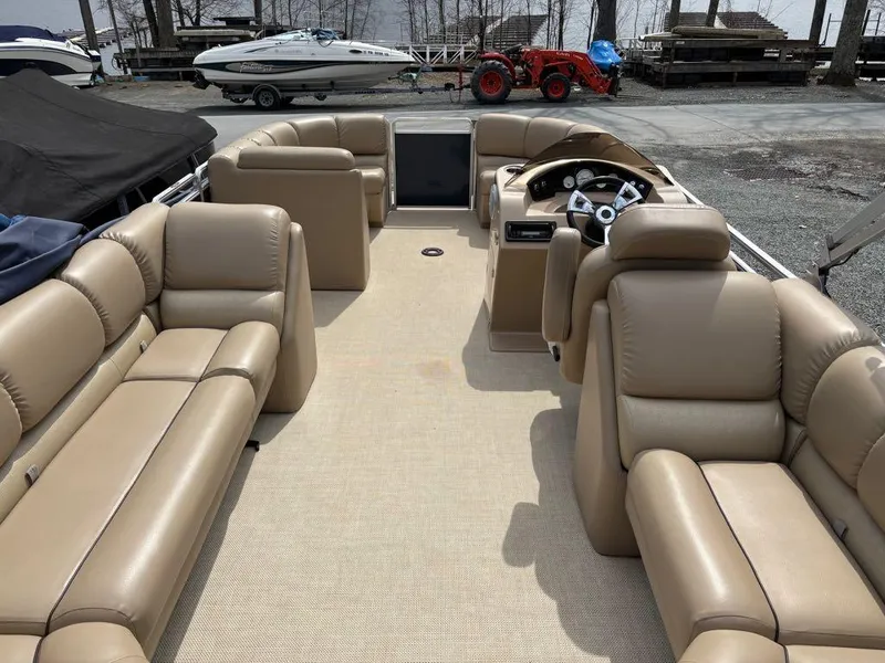 Slide: The Image of 2014 Harris Cruiser 220 pontoon boat with beige seating and steering console. - 20