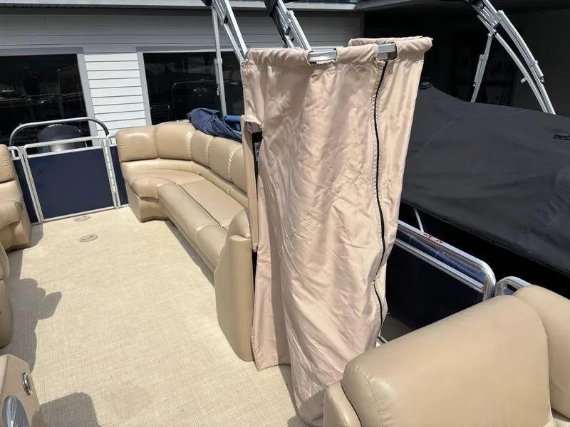 Slide: The Image of 2014 Harris Cruiser 220 pontoon boat with beige seating and privacy curtain. - 4