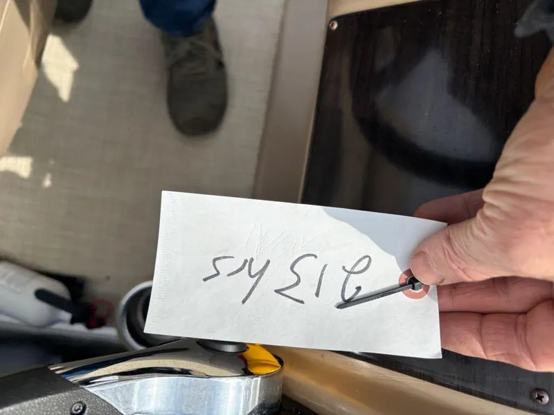 Slide: The Image of Hand holding a tag with numbers on a 2014 Harris Cruiser 220 boat. - 5