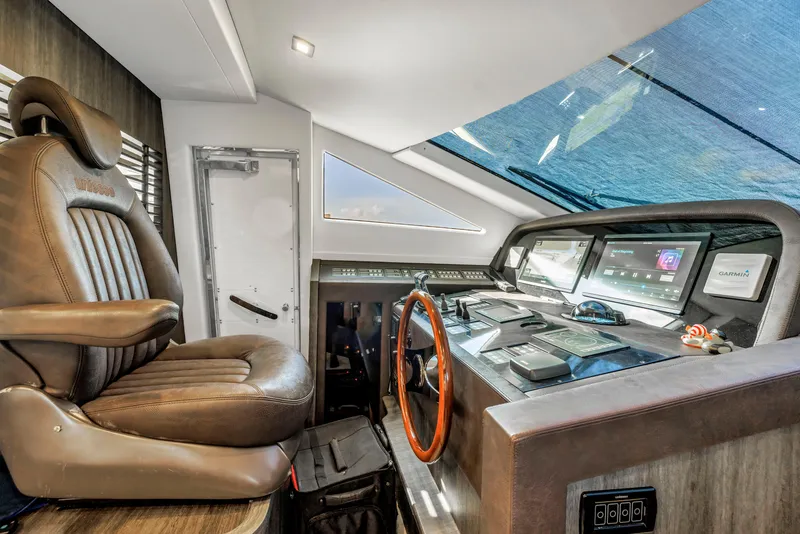 Slide: The Image of Luxurious 2009 Uniesse 65 MY yacht helm with leather captain's chair and advanced navigation controls. - 17