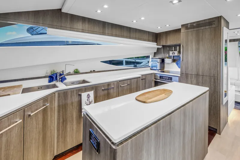 Slide: The Image of Modern kitchen interior on 2009 Uniesse 65 MY yacht, featuring sleek cabinetry and ample counter space. - 19