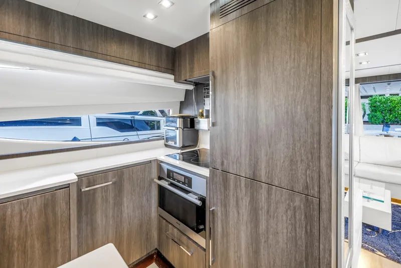 Slide: The Image of Modern kitchen interior on 2009 Uniesse 65 MY yacht, featuring sleek cabinetry and appliances. - 20