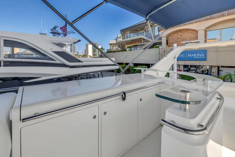 Slide: The Image of 2009 Uniesse 65 MY yacht deck with sleek design and marina backdrop. - 30