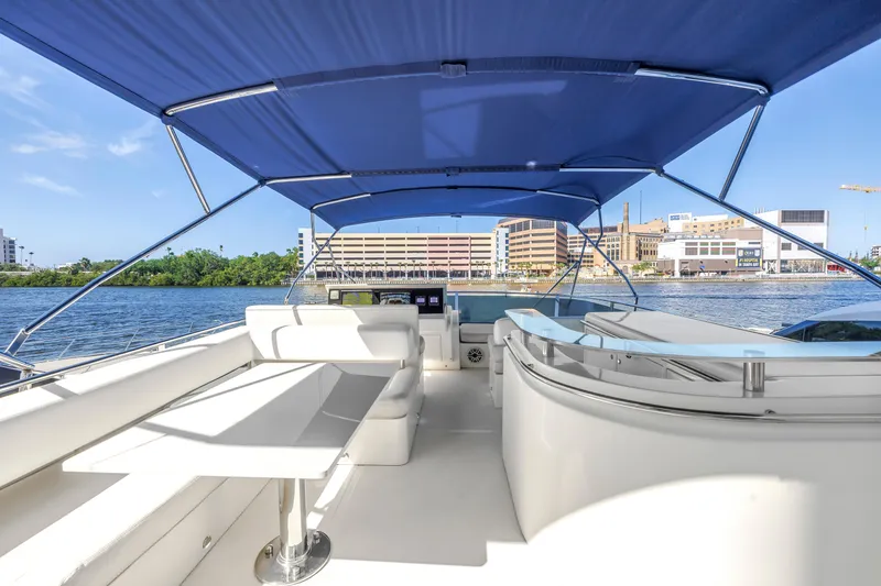 Slide: The Image of Luxurious 2009 Uniesse 65 MY yacht with spacious deck and blue canopy. - 32