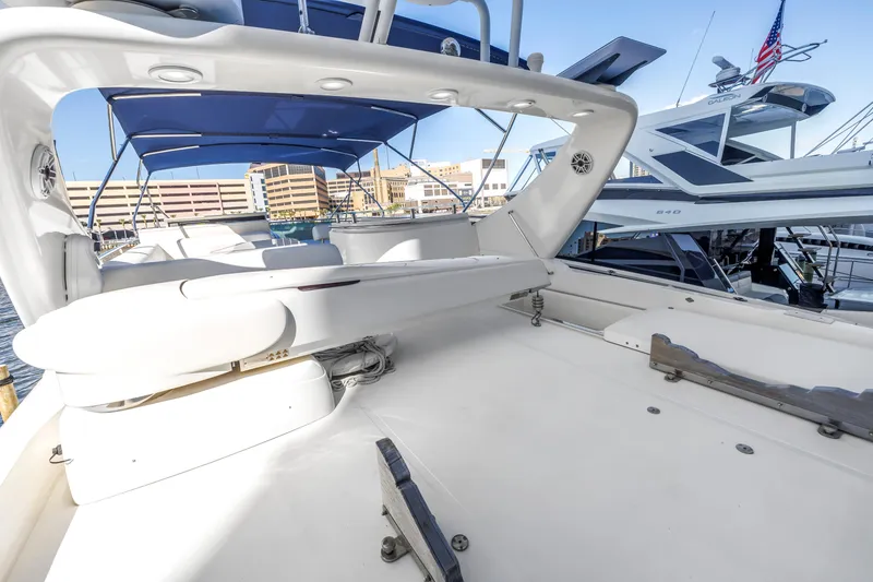 Slide: The Image of Luxury Uniesse 65 MY yacht deck, 2009 model, with blue canopy and marina view. - 34