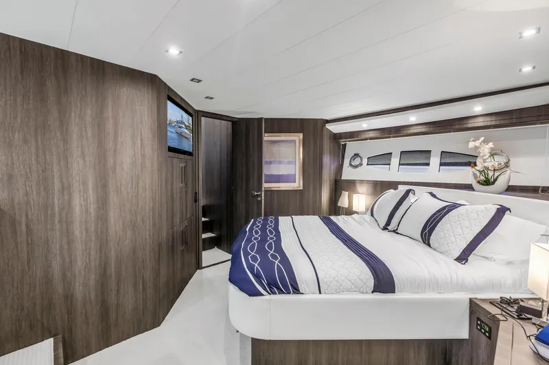 Slide: The Image of Luxurious bedroom interior of 2009 Uniesse 65 MY yacht with modern decor and elegant bedding. - 44