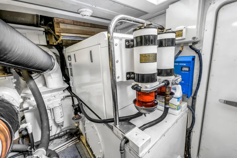 Slide: The Image of Engine room of 2009 Uniesse 65 MY yacht, featuring machinery and filtration systems. - 59
