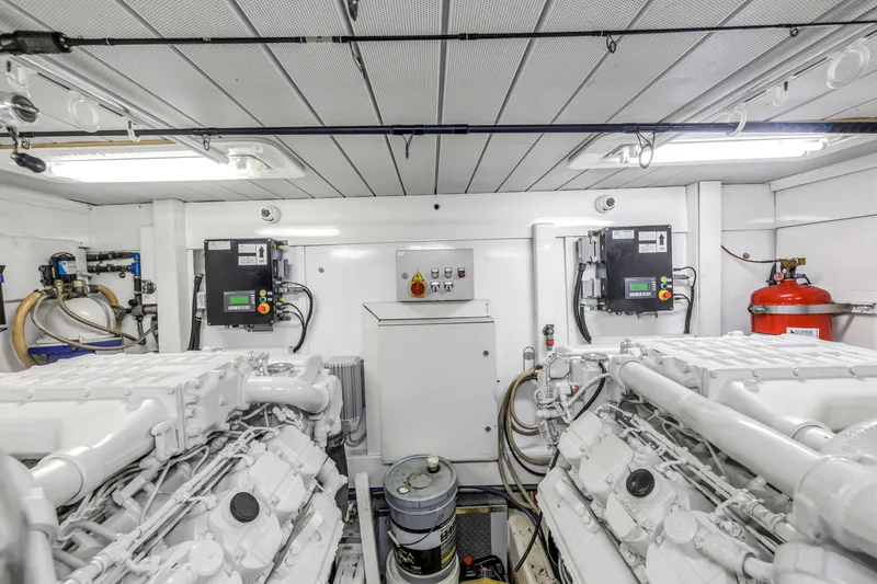 Slide: The Image of Engine room of 2009 Uniesse 65 MY yacht, featuring dual engines and control panels. - 62