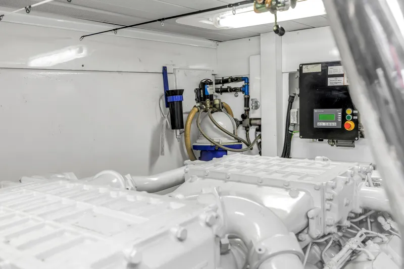 Slide: The Image of Engine room of 2009 Uniesse 65 MY yacht, featuring dual engines and control systems. - 63
