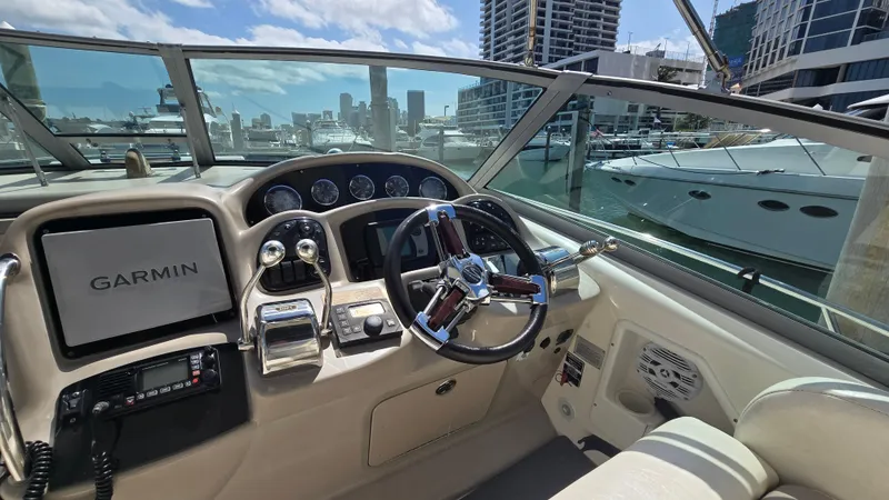 Slide: The Image of Helm of 2003 Sea Ray 340 Sundancer with Garmin navigation, docked in a marina. - 12