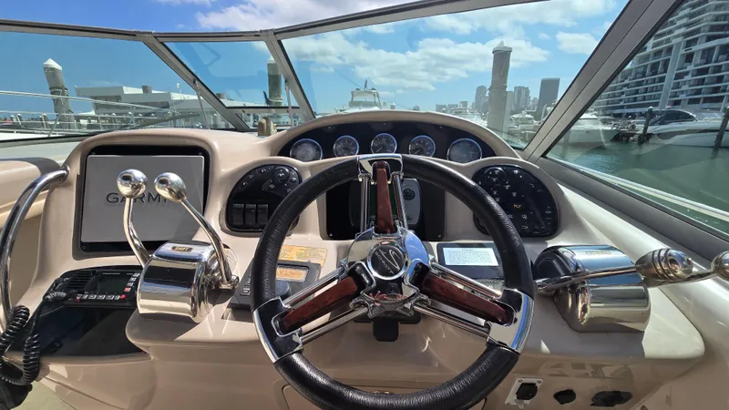 Slide: The Image of Helm of 2003 Sea Ray 340 Sundancer with city skyline in background. - 13