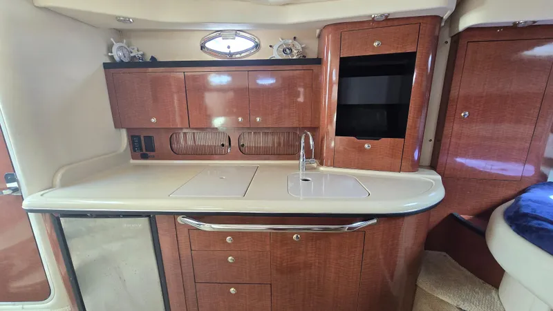 Slide: The Image of 2003 Sea Ray 340 Sundancer kitchen with wood cabinets and modern appliances. - 20