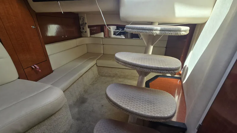 Slide: The Image of Interior of 2003 Sea Ray 340 Sundancer with beige seating and spiral stairs. - 21
