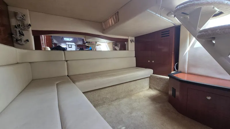 Slide: The Image of 2003 Sea Ray 340 Sundancer interior with beige seating and wooden accents. - 22