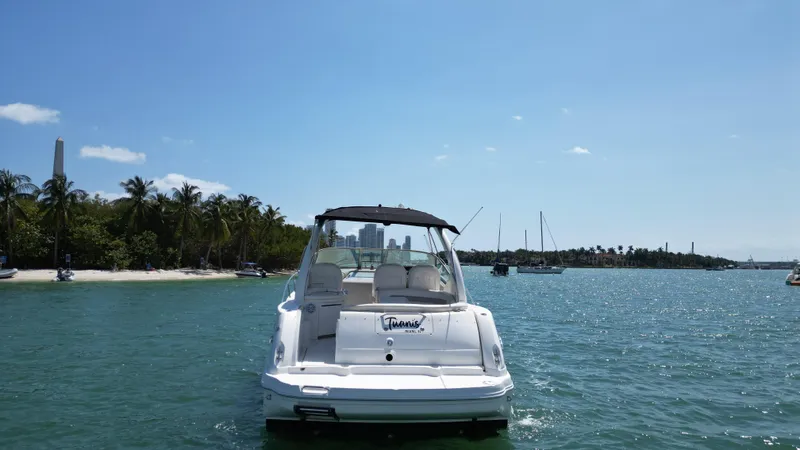 Slide: The Image of 2003 Sea Ray 340 Sundancer boat on calm water near a tropical shoreline. - 4