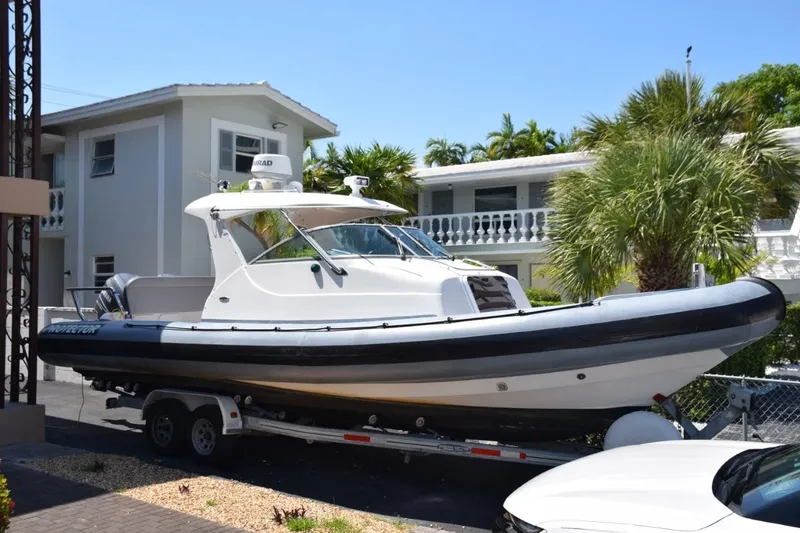 Slide: The Image of 2002 Protector Targa 28 boat on the New River, in Ft. Lauderdale with "little Florida" in the background. - 23