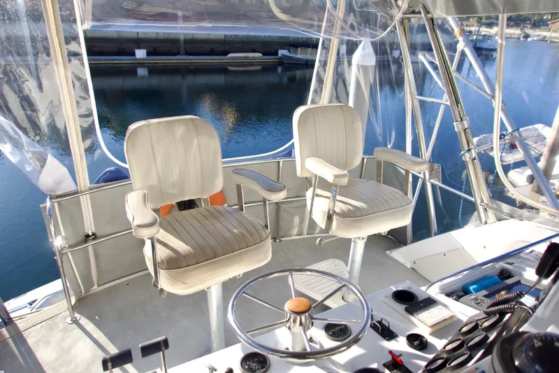 Slide: The Image of Interior view of 1986 Bertram 46 Sportfisher boat with helm and seating. - 13