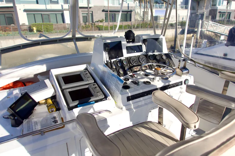 Slide: The Image of 1986 Bertram 46 Sportfisher helm with navigation instruments and controls. - 14