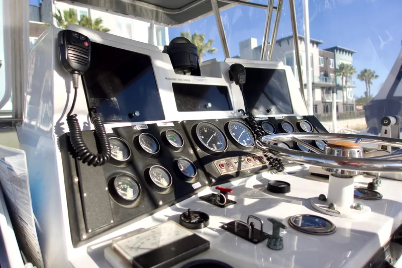 Slide: The Image of Control panel of a 1986 Bertram 46 Sportfisher boat with gauges and steering wheel. - 15