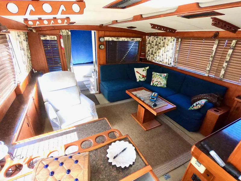 Slide: The Image of Interior of a 1986 Bertram 46 Sportfisher yacht with cozy seating and wooden accents. - 20