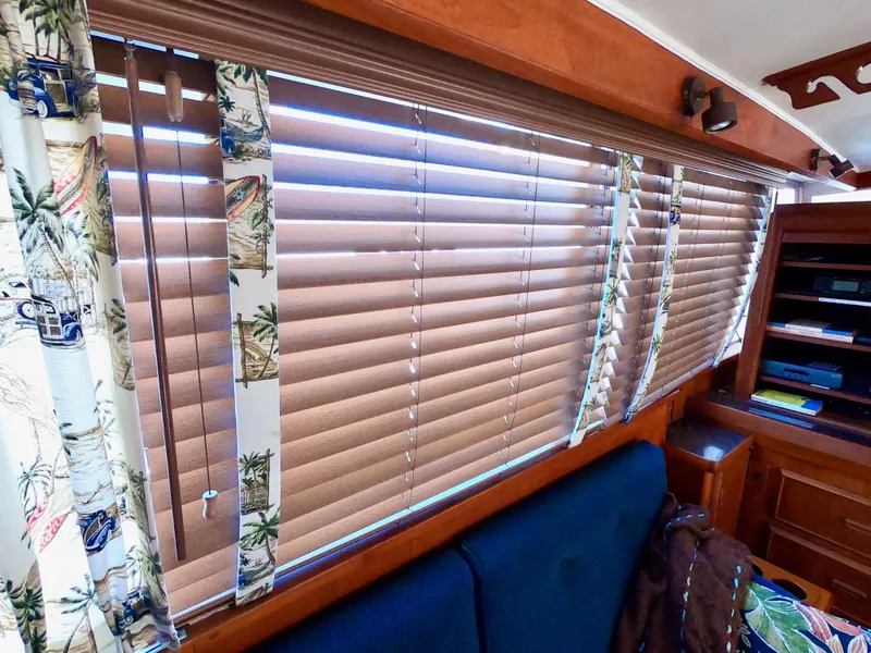 Slide: The Image of Interior of 1986 Bertram 46 Sportfisher with wooden blinds and nautical-themed curtains. - 23