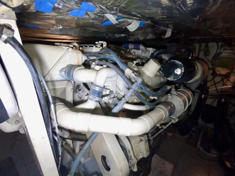 Slide: The Image of Engine compartment of a 1986 Bertram 46 Sportfisher, showcasing complex piping and components. - 37