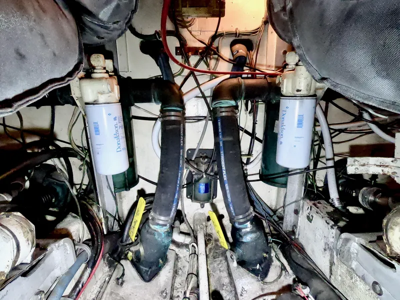 Slide: The Image of Engine room of a 1986 Bertram 46 Sportfisher with visible filters and hoses. - 38