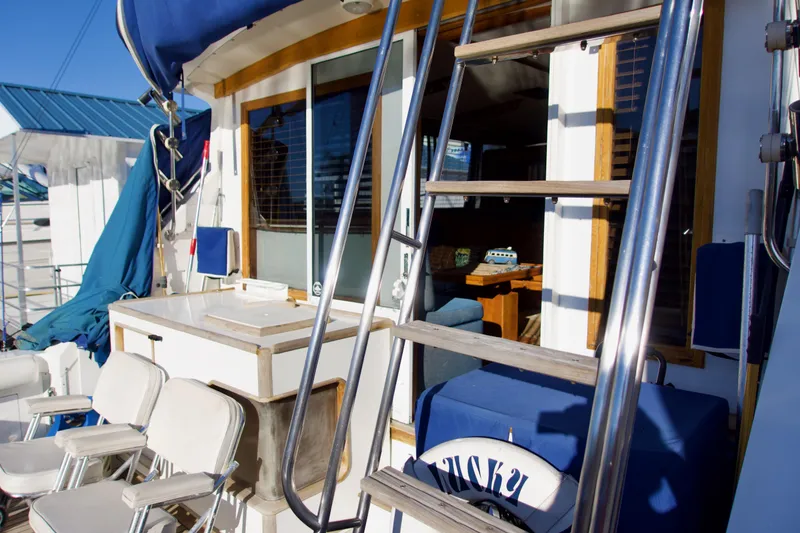 Slide: The Image of 1986 Bertram 46 Sportfisher yacht deck with seating and ladder. - 7